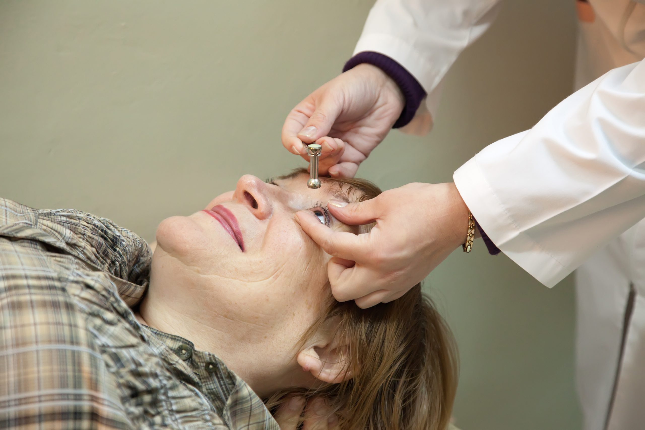 Ophthalmologist measures the  ocular tension in patients
